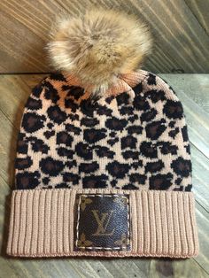 Leopard Print Beanie with Pom Pom DISCLAIMER-- We do NOT sell licensed Louis Vuitton products. This is an upcycled item made from new products and used LV bags. We legally purchase items from wholesale vendors who use previously loved items to create our upcycled products. Southern Diva Designs is in NO WAY associated or affiliated with Louis Vuitton and/or their subsidiaries. Upcycled Products, Leopard Print Beanie, Beanie With Pom Pom, Louis Vuitton Hat, Beanie With Pom, Wholesale Vendors, Diva Design, Lv Bags, Trendy Fashion Outfits