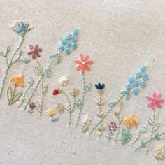 embroidered flowers on white fabric with beading