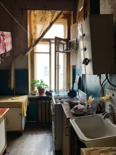 an old kitchen with dirty walls and wooden flooring is shown in the foreground