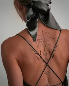 the back of a woman's neck with a black bow