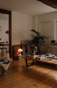 a living room filled with furniture and a wooden table in front of a large window