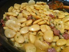 pasta with ham and cheese in a skillet ready to be cooked on the stove