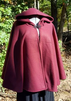 This short cloak is delightfully soft and comfortable. It's long enough to reach the back of the hand, keeping you warm but keeping your hands available when needed. It has a full hood and closes with a matching cloth frog clasp. This cloak is great for a costume piece or a cozy jacket, great for Spring, Fall, or over air conditioned buildings.Your cloak will measure about 30 inches in length. This listing is in a lovely burgundy wine color but other colors are available in my store or on reques Short Cloak, Medieval Cloak, Cape With Hood, Cozy Jacket, Hooded Cape, Creative Challenge, Burgundy Wine, Wine Color, Spring Jackets