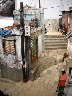 an old building with graffiti on the walls and steps leading up to it's entrance