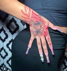 a woman's hand with flowers painted on it