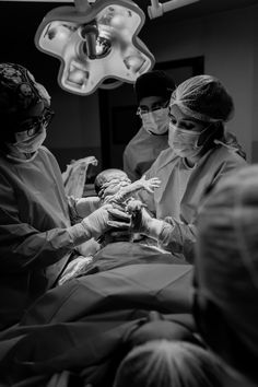 black and white photograph of doctors performing surgery