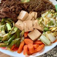 a white plate topped with meat and veggies