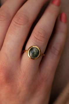 One of a kind is an understatement when it comes to our Juno ring. The main attraction is the Moss Agate stone. An authentic gemstone, each one unique with the mossy texture captured, the Juno ring compliments any style and is the perfect unique gift for a loved one. Details: Center Gemstone: Moss Agate Stone Shape: Round Measurements: 10mm Band measurements: approx. 1.8mm wide, approx. 1.5mm thick Pictured in vermeil, available also in sterling silver or rose gold vermeil. Gold vermeil is not t Nature-inspired Moss Agate Round Rings, Nature-inspired Moss Agate Rings, Pretty Trinkets, Planet Ring, Black Spinel Ring, Moss Agate Stone, Moss Agate Ring, Jewellery Sketches, London Blue Topaz Ring