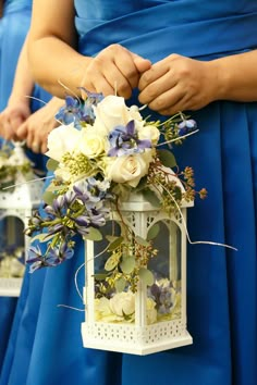 the bridesmaids are holding their bouquets in white lanterns