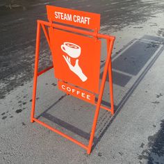 an orange sign that says steam craft coffee