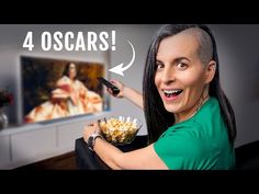 a woman holding a bowl of popcorn in front of a tv with the words 4 oscars on it