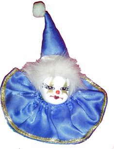 a clown mask with white hair and blue dress