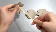 someone is making hearts out of paper on a stick