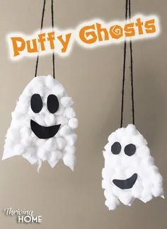 two paper ghost hanging from strings with the words puffy ghosts on them