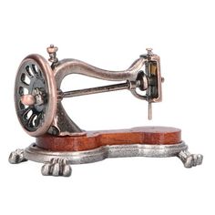 an old fashioned sewing machine on a wooden base with metal wheels and knobs, isolated against a white background