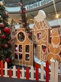 a christmas display with gingerbread houses and trees