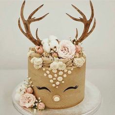 a cake with flowers and antlers on top