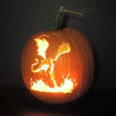 an elephant carved into a pumpkin in the dark