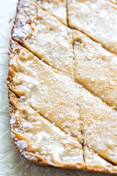 a piece of cake sitting on top of a white paper covered in powdered sugar