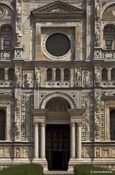 an ornate building with statues on the front and side doors, in italy's ancient city of pisa