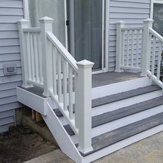 a white porch with steps leading up to the front door