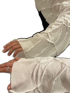 a pair of white gloves with ruffles on the arms and fingers are shown in front of a white background