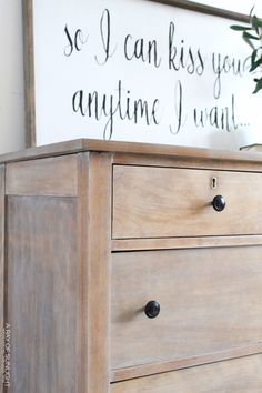 a wooden dresser with a sign above it that says so i can kiss you anytime i want