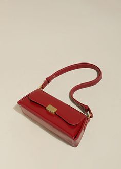 Indulge in sophistication and style with our Red Leather Baguette Shoulder Bag. The flap lock closure and adjustable strap combine practicality with elegance. The structured silhouette and flat base provide stability, while the interior slip pockets enhance organization. Handcrafted with genuine cowhide leather, this women's shoulder bag is the epitome of luxury. Size info 11" (28cm) width 4"(10cm) height 6 3/4"(17cm) depth Details Flap lock closure Adjustable shoulder strap Structured silhouett Classic Clutch Baguette Bag With Adjustable Strap, Classic Satchel Baguette Bag For Business, Luxury Red Shoulder Bag With Turn-lock Closure, Classic Baguette Bag With Gold-tone Hardware For Daily Use, Classic Baguette Bag For Daily Use, Classic Baguette Bag With Hasp Closure, Classic Clutch Baguette Bag, Square Baguette Bag With Hasp Closure For Office, Classic Business Baguette Shoulder Bag