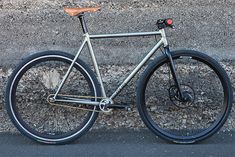 a bike parked next to a stone wall