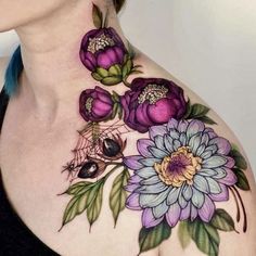 a woman's chest with flowers and spider tattoo on her left side, while the upper half of her body is visible