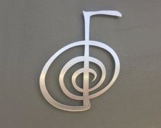 the letter f is made out of metal and has a treble on it's side