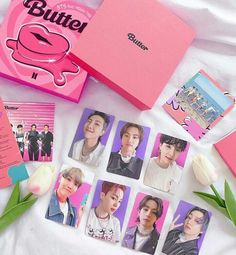 a pink box with some pictures on it and tulips next to the package