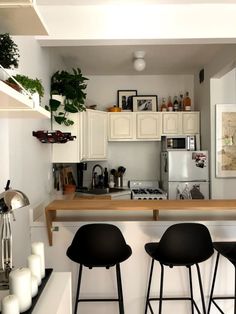 three bar stools sit in front of the kitchen counter