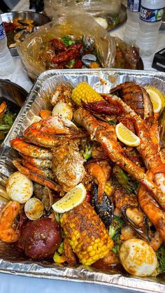 a tray full of seafood and vegetables on a table