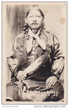 an old black and white photo of a woman with long hair wearing a fur stole