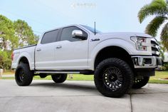 a white truck parked on top of a driveway