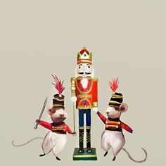 three toy mice dressed up as nutcrackers with swords and helmets on their heads