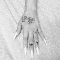 a woman's hand with some tattoos on it