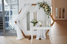 a white table with flowers and candles on it