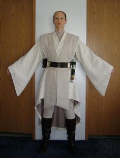 a man dressed as luke sky walker is standing in front of a door with his hands on his hips