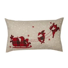 a christmas pillow with santa riding a sleigh