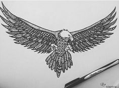 a drawing of an eagle on paper with a pen next to it and a marker