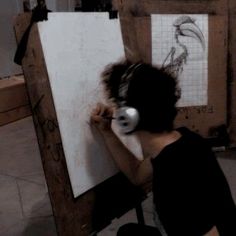 a person sitting in front of a drawing board