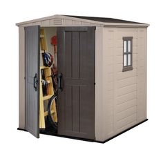 a storage shed with the door open and shelves full of tools in front of it