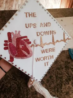 a decorated graduation cap with the words, the ups and downs were worth it