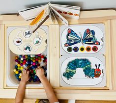 a child's hands playing with the caterpillars and butterfly matching cards