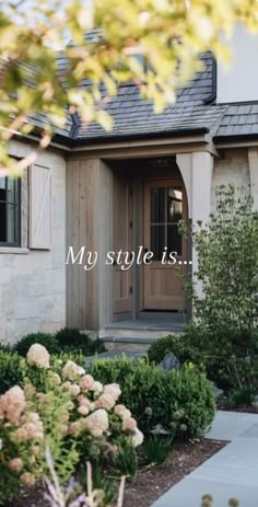 the front door of a house with flowers and bushes in front of it that says, my style is