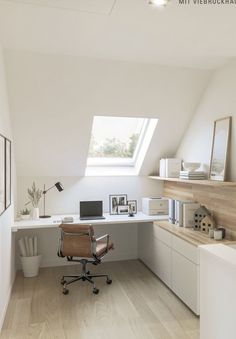 an office space with white walls and wooden flooring, along with a skylight above the desk