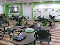 an empty classroom with laptops and desks