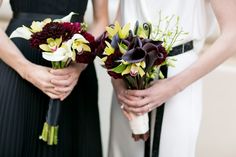 two bridesmaids holding bouquets of flowers in their hands and wearing black dresses